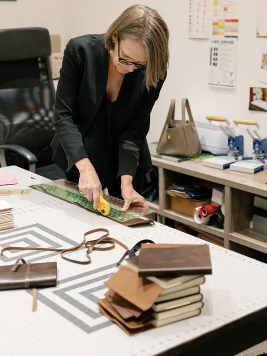 Jenni Bick assembling leather journals